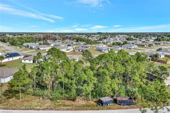 Aerial perspective of suburban area with a tree filled landscape