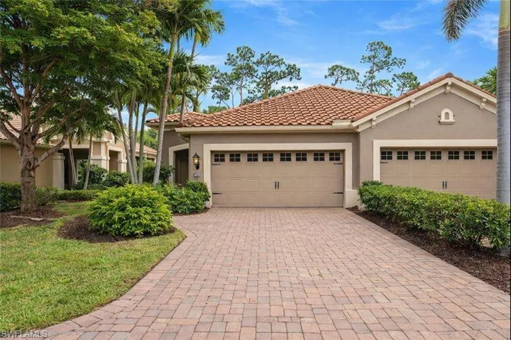 Mediterranean / spanish-style home featuring stucco siding, driveway, a tile roof, and a garage