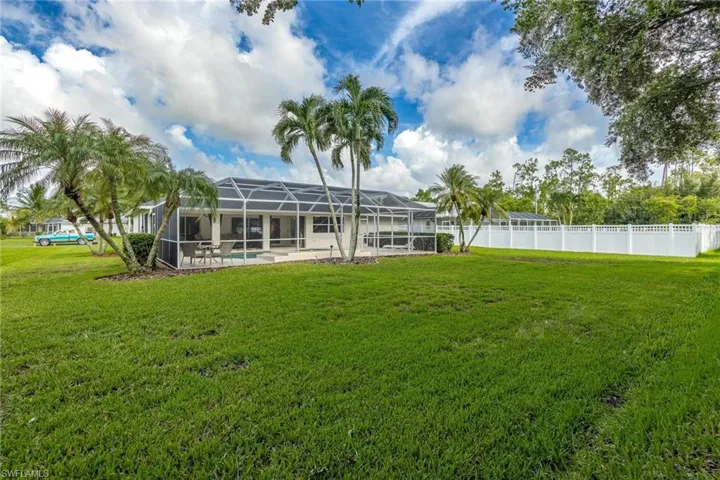 View of yard featuring a fenced in pool and screen enclosure