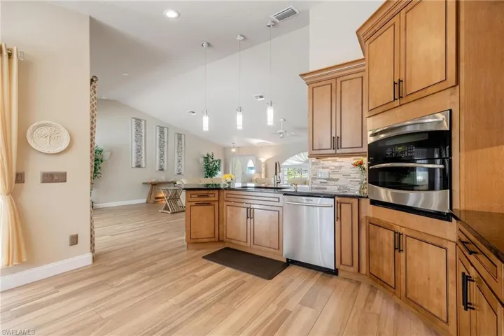 Kitchen with light plank tile flooring,
