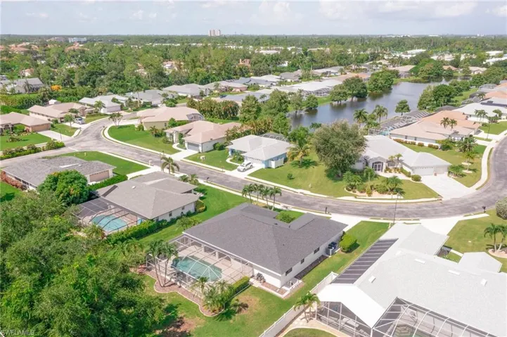 Birds eye view of property with a water view