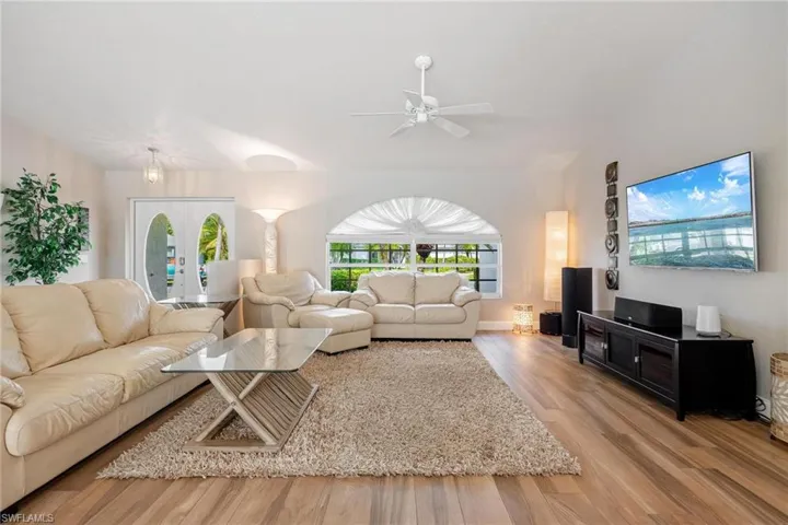 Living room featuring french doors and plank tile flooring,