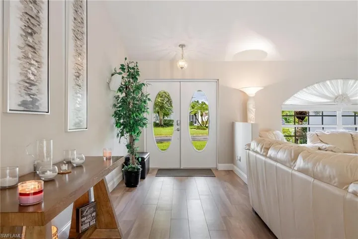 Entrance foyer featuring plank tile flooring and french doors
