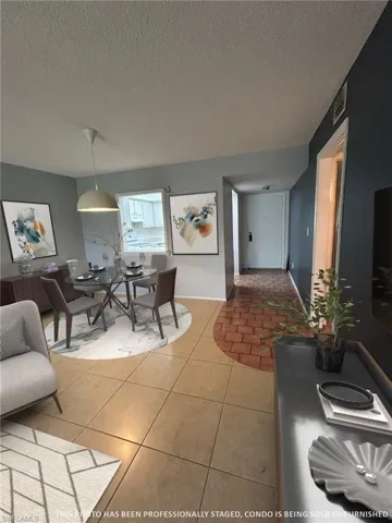 LIVING ROOM AREA THAT LEADS INTO THE DINING ROOM