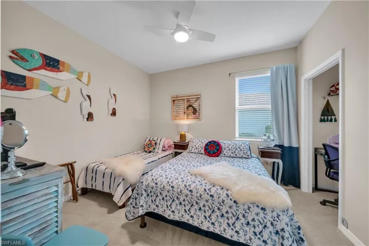Bedroom featuring light carpet and a ceiling fan