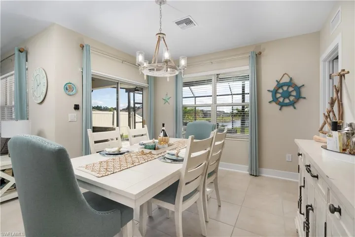 Dining room featuring a chandelier and light tile patterned floors