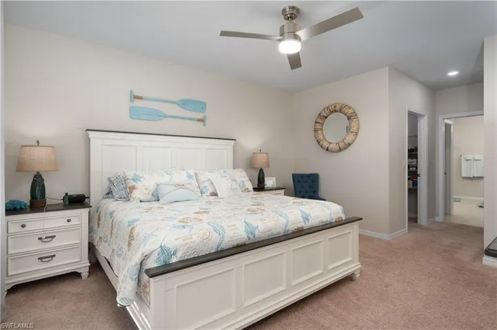 Bedroom featuring light colored carpet and a ceiling fan