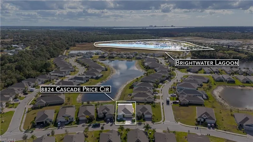 Aerial view of property's location with nearby suburban area and a large body of water