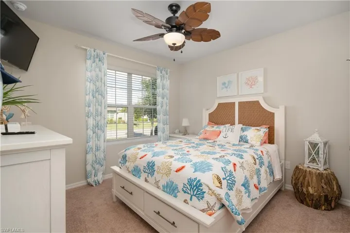 Bedroom featuring light carpet and a ceiling fan
