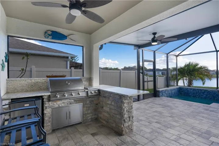 Fenced backyard with a patio, glass enclosure, a sunroom, and an outdoor pool