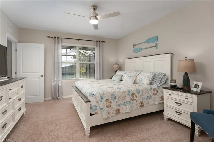 Bedroom with light carpet and ceiling fan