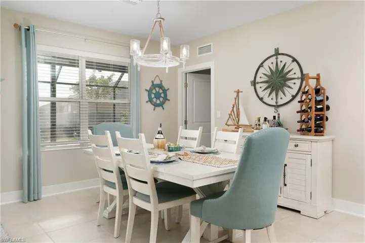 Dining area with a chandelier and light tile patterned floors