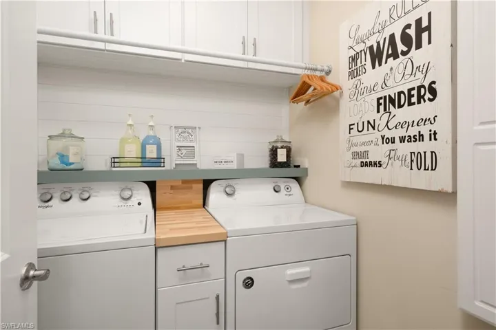 Laundry area featuring cabinet space and independent washer and dryer