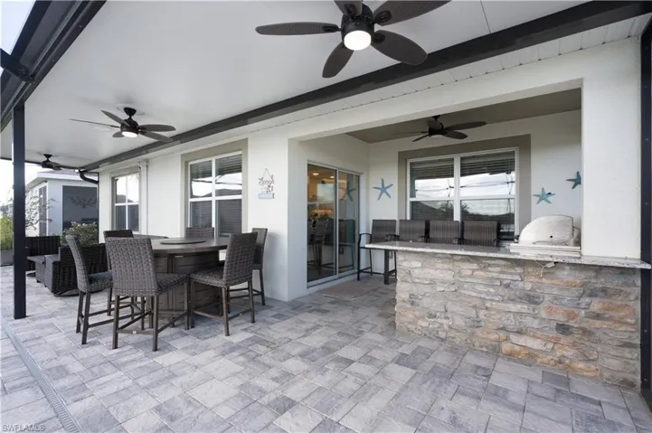 View of patio / terrace with a ceiling fan and area for grilling