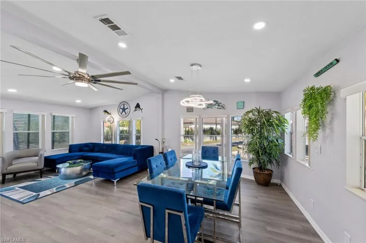 Dining room featuring wood finished floors, a ceiling fan, and recessed lighting