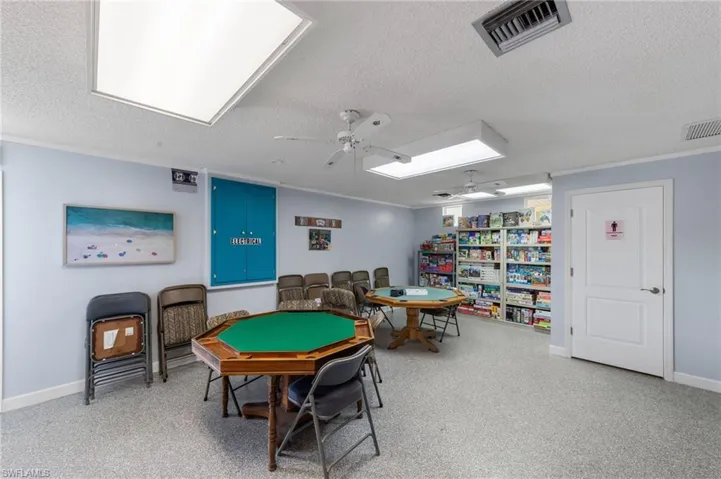 Rec room featuring a textured ceiling and ceiling fan
