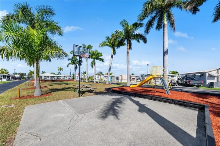 Communal playground with a residential view and a lawn