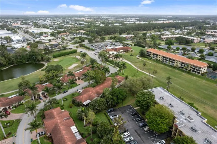 Bird's eye view of a golf course and a nearby body of water