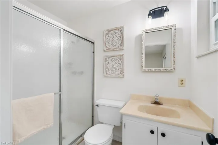 Full bath with vanity and a shower stall