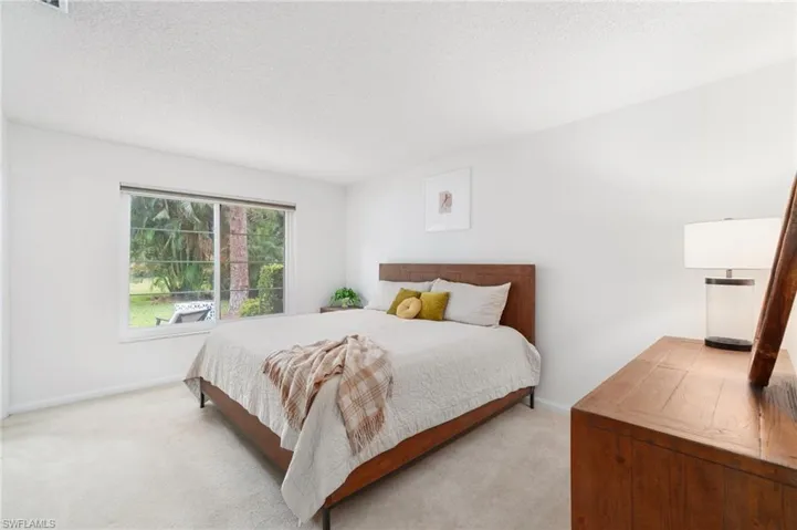 Bedroom featuring a textured ceiling and carpet flooring
