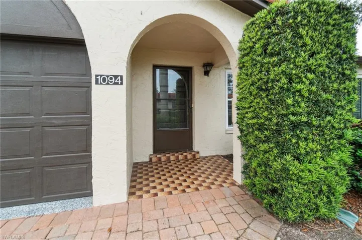 Doorway to property with stucco siding