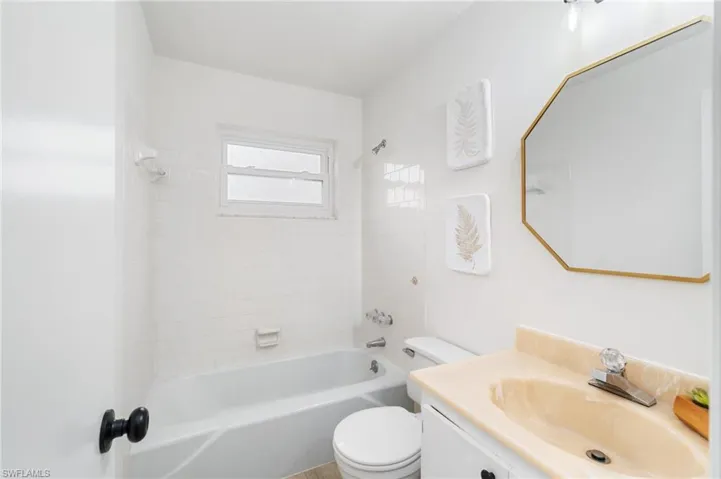 Bathroom with vanity and bathing tub / shower combination