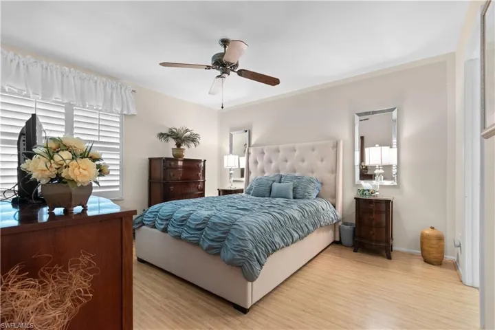 Primary bedroom with bamboo floors and large walk-in closet.