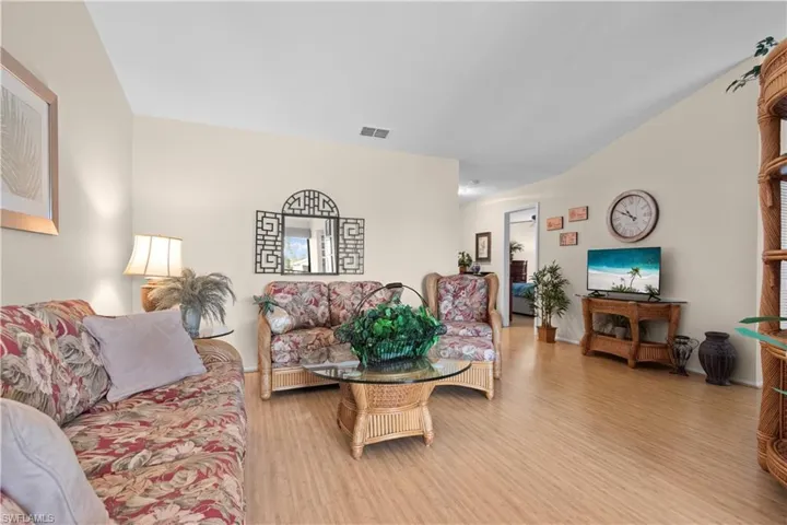 Living room with wood finished floors and vaulted ceiling