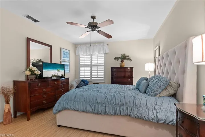 Primary bedroom with bamboo floors and large walk-in closet.