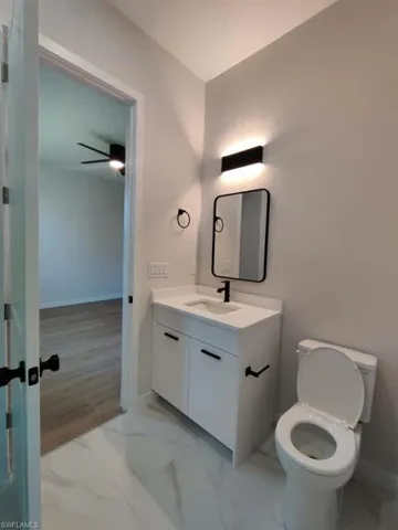 Bathroom with vanity and light marble finish floors