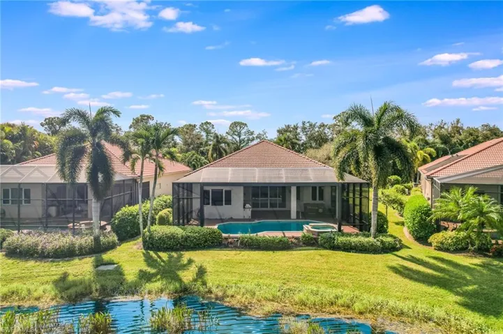 View of swimming pool featuring a lawn and a lanai