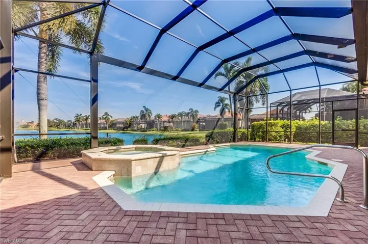 View of swimming pool featuring a water view, an in ground hot tub, a lanai, and a patio area