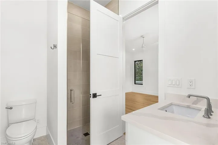 Full bathroom featuring vanity, a stall shower, and light tile patterned floors