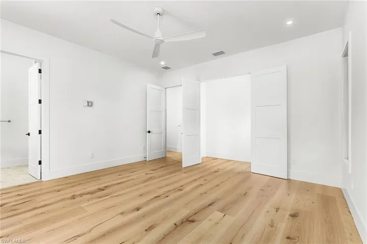 Unfurnished bedroom with light wood-style floors, ceiling fan, and recessed lighting