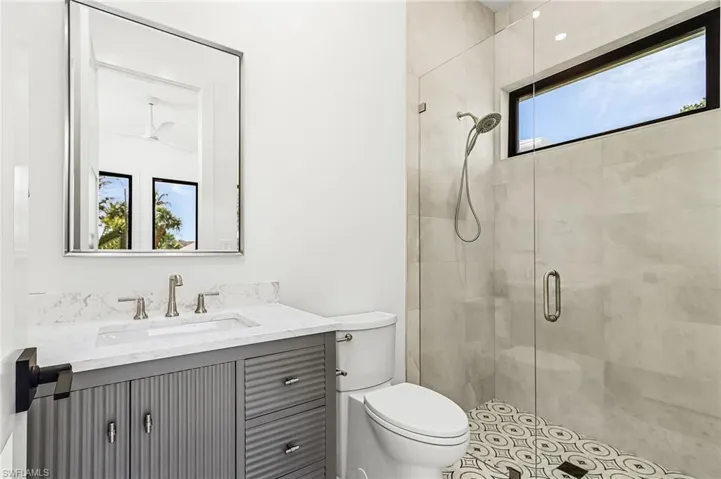 Full bathroom featuring vanity and a stall shower