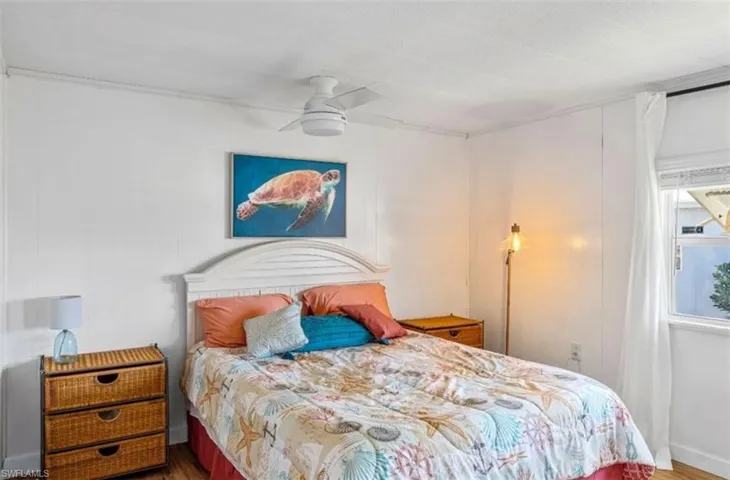 Bedroom featuring wood finished floors and ceiling fan