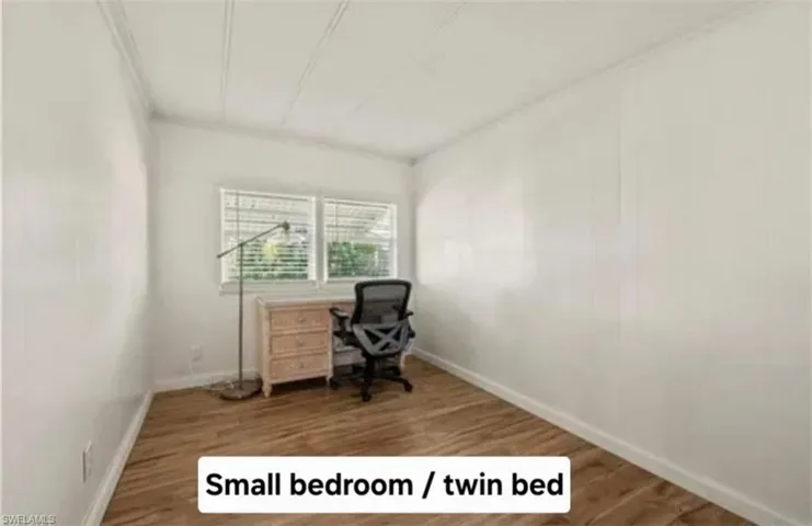 Home office with wood finished floors