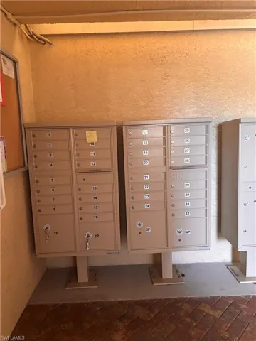 Community mailboxes featuring individual parcel lockers and a herringbone brick-patterned walkway