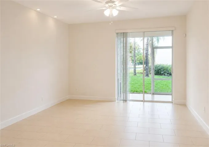 Expansive room featuring tile flooring, a ceiling fan with integrated lighting, and recessed ceiling lighting