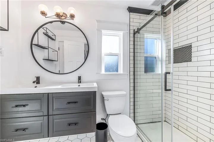 Bathroom featuring vanity, and an enclosed shower