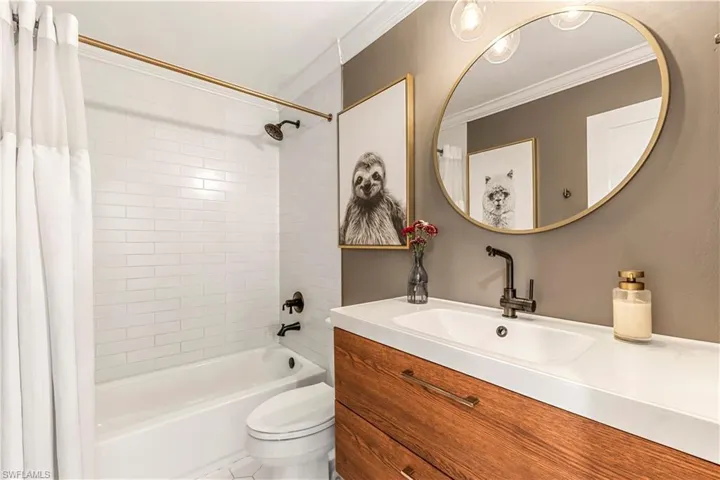 Guest bathroom with vanity, shower / bath combo.