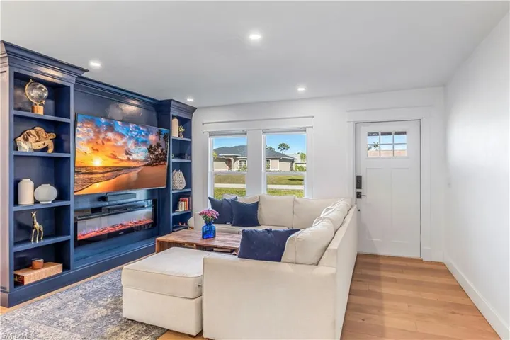 Living room with a wealth of natural light and hardwood flooring