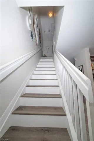 Staircase featuring wood-finish treads and white risers