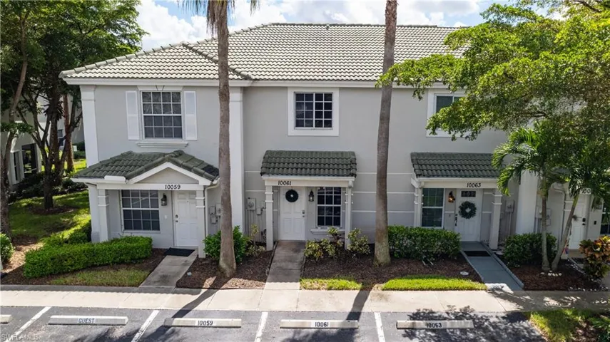 Tiled roof, shuttered windows, recessed entryways, covered porches, and mature landscaping