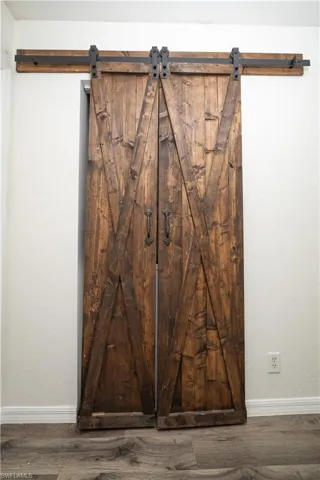 Dark wood-finish barn doors with matte black hardware