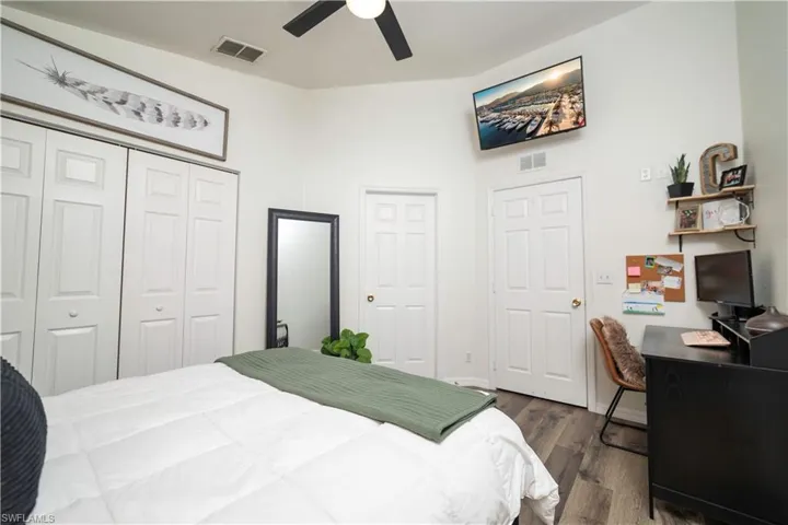 Vaulted ceilings, wood-finish flooring, ceiling fan, bi-fold closet doors, and solid panel doors