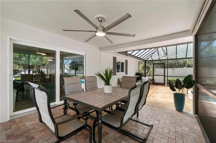 The screened in tile patio features 2 covered seating areas through the slider door.