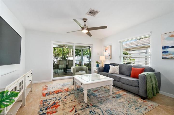 Family room leads out to spacious expanded pool patio though impact slider doors.