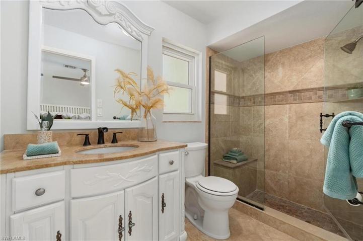 Primary En-Suite Bathroom is highlighted by tiled stone shower enclosure.