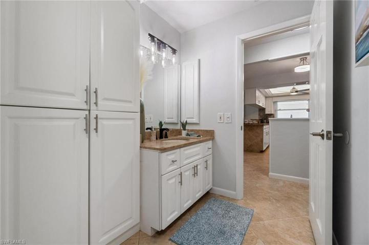 2nd Full Bathroom features full wall linen storage and updated vanity and granite counter vanity.